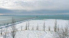 Aerial 4k Shot Of Frozen Lake Michigan Lighthouse And Pier. Location St. Joseph Michigan.