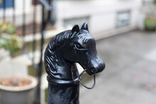 Philadelphia, PA - March 26 2021: Metal Black Horse Head Hitching Post. Historical Piece In Front Of A Blurry Home In Philadelphia