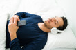 © AntonioDiaz - Hispanic man relaxing with a meditation in his bedroom