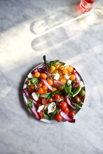 A Healthy Tomato Salad Against A Marble Background