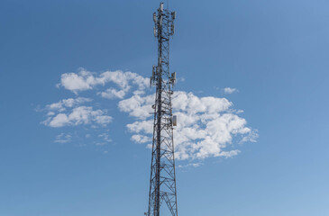 Wall Mural - Cell phone data transmission tower on blue natural background