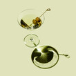 © The Picture Pantry - Classic Martini Cocktail with green olives on green background