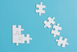 © khemfoto - White jigsaw puzzle on blue background.