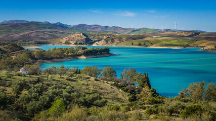 View on the turquoise water of the Guadalhorce and Guadalteba Reservoirs, two artificial lakes in the andalusian backcountry in Spain