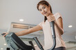 © KMPZZZ - Workout woman, girl, exercise on elliptical cross trainer in fit sportswear, practice working out training for health. Sport strong person in gym fitness for healthy lifestyle, recreation concept.