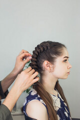 master makes a hairstyle for a girl, beautiful curls