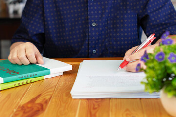 Wall Mural - working hands on paperwork with books