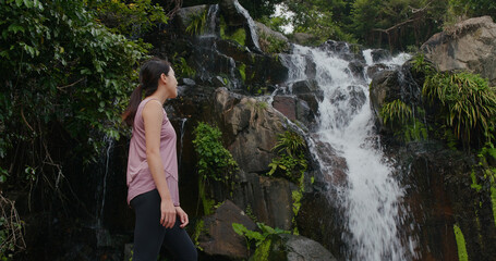 Sticker - Sport woman look around with waterfall background