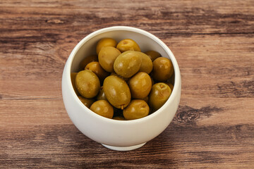 Green pickled olives in the bowl