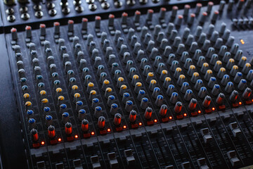 Professional audio studio sound mixer console board panel with recording , faders and adjusting knobs,TV equipment.