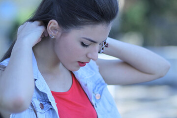 Poster - Portrait of a modest young brunette female looking down