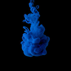 Wall Mural - Explosion of colored, fluid and neoned liquids on black studio background with copyspace