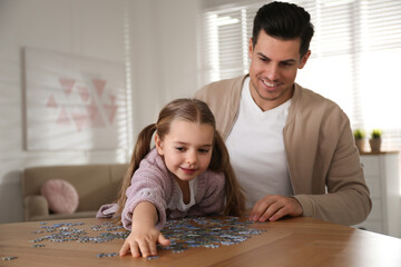 Sticker - Man and his little daughter playing with puzzles at home