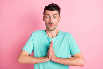 Sticker - Photo of young shocked amazed surprised unhappy anxious man hold hands in prayer isolated on pink color background