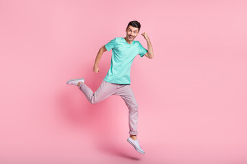 Sticker - Full body photo of young excited man go run jump rejoice victory fists hands isolated over pastel color background