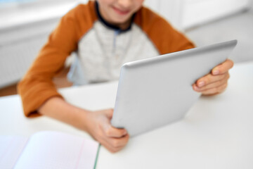 Sticker - children, education and school concept - happy student boy with tablet pc computer learning at home