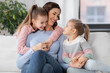 © Syda Productions - people, family and love concept - happy smiling mother with two daughters at home