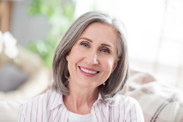 Photo of cheerful positive pretty old woman smile charming happy face free time indoors inside house home