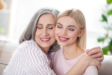 Sticker - Photo of attractive happy nice family mother and young woman smile hug cheeks smile indoors inside house