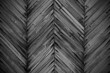 Old black wooden planks in the form of a herringbone pattern. Close-up. Background. Texture.