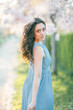 © Kristina89 - Beautiful young woman with curly hair is resting in the blooming sakura garden.