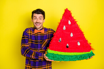 Sticker - Photo of happy smiling cheerful good mood excited man hold huge watermelon piece isolated on yellow color background