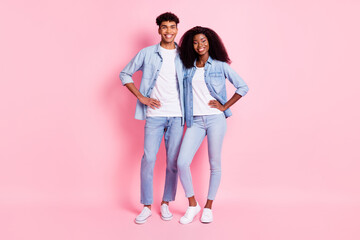 Canvas Print - Full length photo of two positive dark skin people standing put hands on waist isolated on pink color background