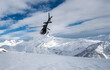 © Vitaliy Honor  - helicopter flying away towards snowy mountain peaks