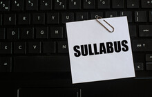 SULLABUS - Word On A White Sheet Against The Background Of The Laptop Keyboard