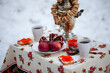 Tea drinking from a samovar in the winter outdoors in the forest. Russian traditions. Tea from a samovar. Tea with bagels.