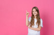 girl 10 years old in a white top shows up on a pink background