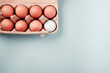 Golf ball in a box of eggs, flatlay on blue background