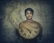 Time passing by concept. Time fading away. A young man holding a clock that is fading away.