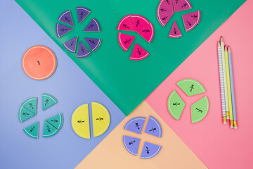 Wall Mural - Multicolored math fractions on the violet green pink background. Interesting mathematics, geometry shapes for kids. Education, back to school concept