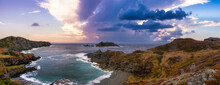 Striking Panoramic Seascape View On A Rocky Atlantic Ocean Coast During A Vibrant Sunset. Dramatic Sky Art Render. Taken At Crow Head, North Twillingate Island, Newfoundland And Labrador, Canada.