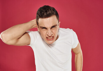 Man in white t-shirt displeased facial expression closeup emotion