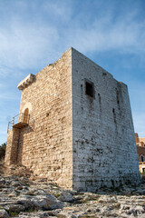 Sticker - Vertical shot of an ancient castle with white bricks on the blue sky background