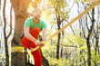 © yanik88 - A bearded man in age balances while sitting on a taut slackline in the autumn forest. Outdoor Leisure