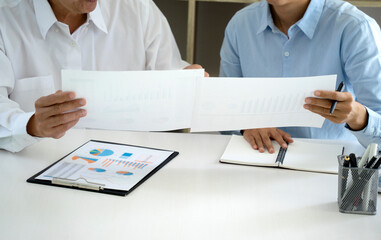 Wall Mural - businessman and team are picking document graph  statistical chart