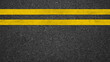 Surface grunge rough of asphalt, Dark grey with double yellow line on the road and small rock, Texture Background, Top view