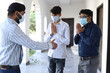 © Media Nation/Wirestock - Closeup of three Indian men wearing facemasks, talking outdoors