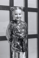 Wall Mural - Little girl posing in studio near a large panoramic window