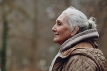 Portrait Profile Of Smiling Gray Haired Elderly Woman Outdoor