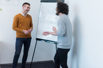 Wall Mural - Group of people listening to a presentation speech and working and communicating together in creative office