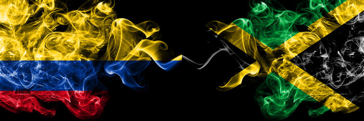 Wall Mural - Colombia, Colombian vs Jamaica, Jamaican smoky mystic flags placed side by side. Thick colored silky abstract smokes flags.