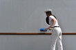 girl military sailor cadet washes the keel of the ship with a brush