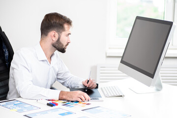 application design. man develops application interface design. designer works with a graphic tablet 