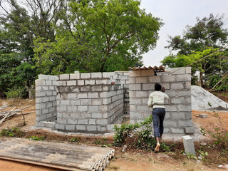 Canvas Print - Bricklayer working on the construction of a new building in the rural area