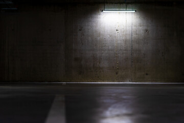 Canvas Print - Empty parking lot with an overhead dim light, underground parking garage