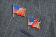 Two flag pins on a lapel